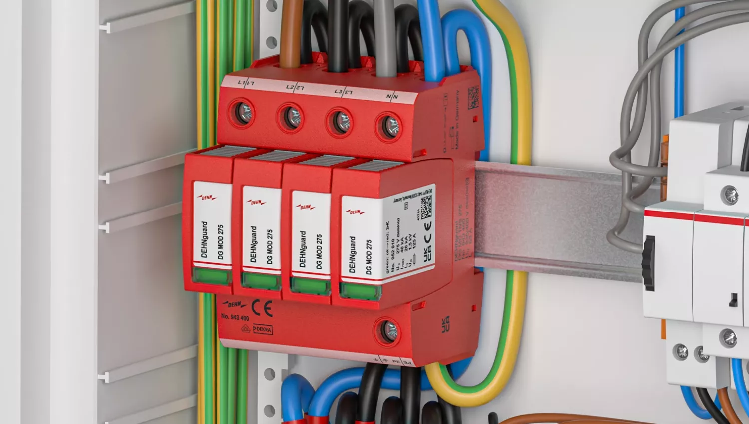 Red surge protection device mounted on a DIN rail inside an electrical cabinet, connected to color-coded cables and adjacent components.