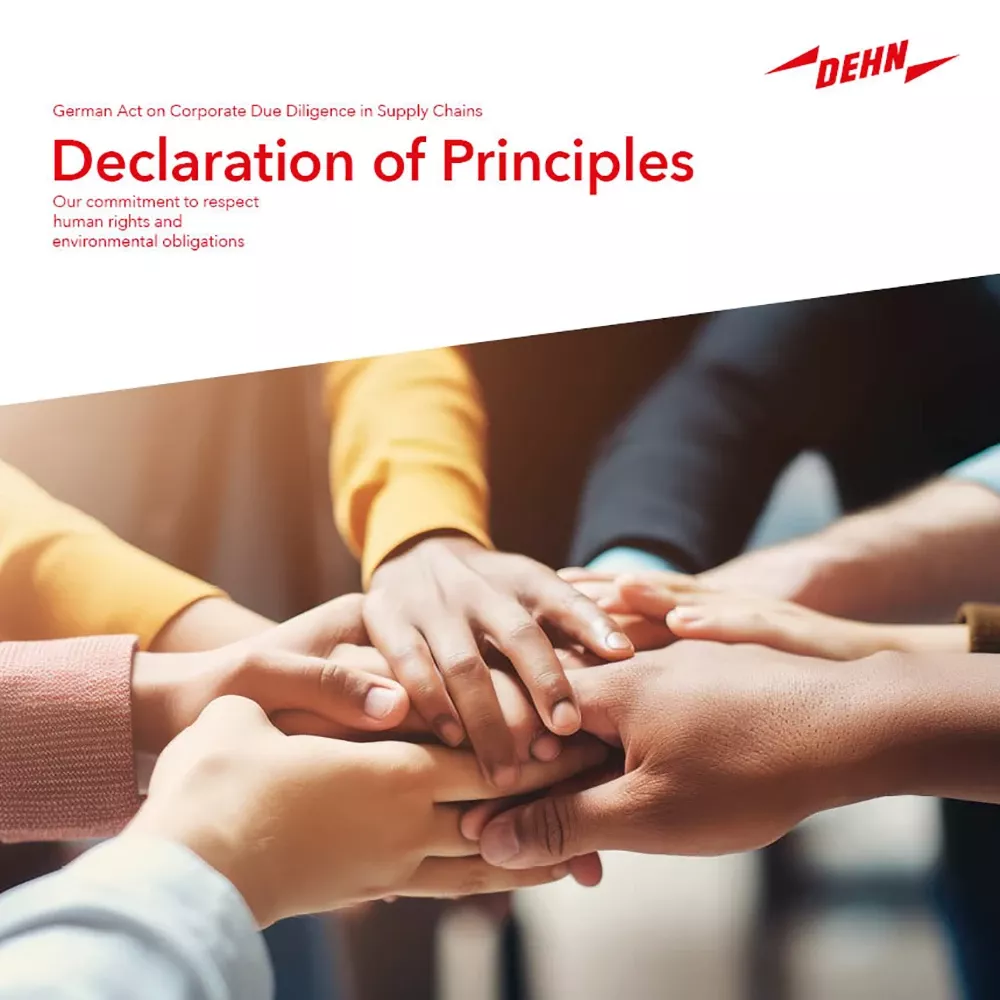 Hands of several people stacked together, symbolizing commitment to human rights and environmental responsibility in supply chains.