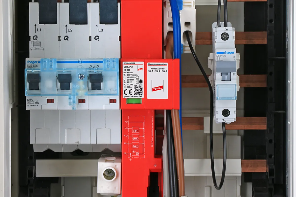 Close-up of an electrical distribution board showing circuit breakers, wiring, and a prominent DEHNshield ZP surge protection device.