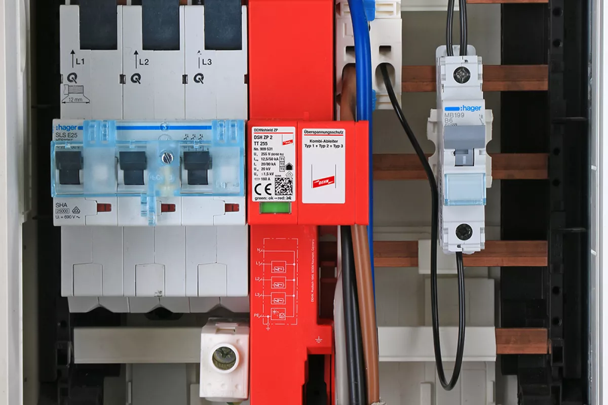 Close-up of an electrical distribution board showing circuit breakers, wiring, and a prominent DEHNshield ZP surge protection device.